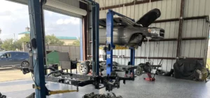 Drive Line Service inspection with vehicle on lift showing drivetrain and driveshaft components