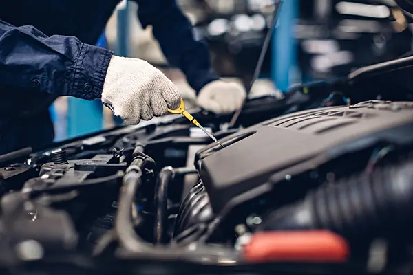 mechanic checking engine oil