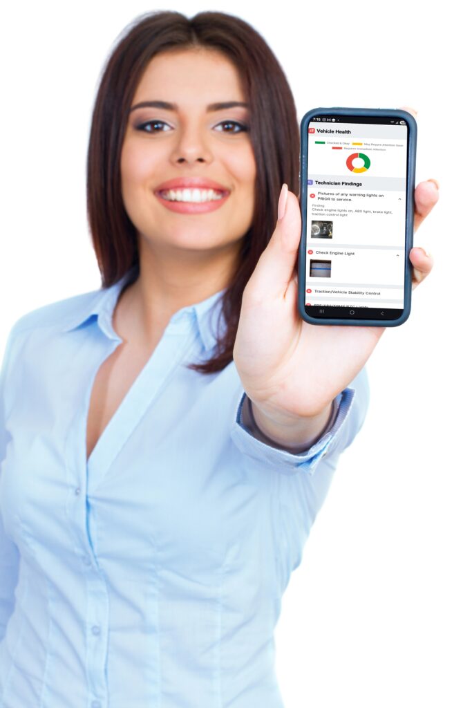 Happy customer looking at her digital vehicle inspection on her cell phone.